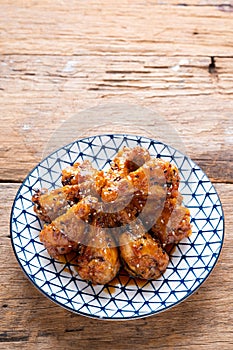 Sour-sweet baked chicken wings sesame and  teriyaki sauce