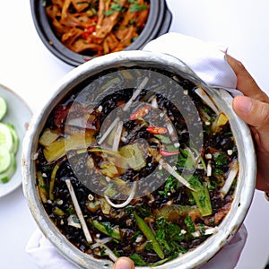 Sour vegetables soup bowl for vegan meal from nutrition ingredient food as seaweed, bamboo shoot, tomato, okra, pine apple