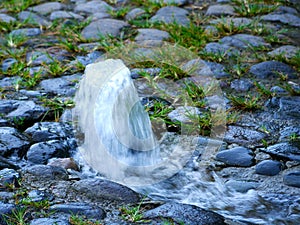 Source of clean water on a stone paved road
