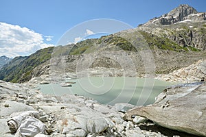 Source of Rhone river, small lake created from melting Rhone Glacier close to Furkapass in Switzerland