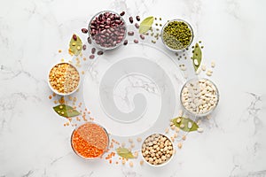 Sources of vegetable protein. Different types of beans and cereals in bowls form a circle. Vegan and vegetarian food