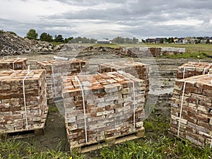 Sourcing red brick from demolition. Stacks of bricks prepared for sale