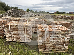 Sourcing red brick from demolition. Stacks of bricks prepared for sale