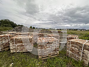 Sourcing red brick from demolition. Stacks of bricks prepared for sale