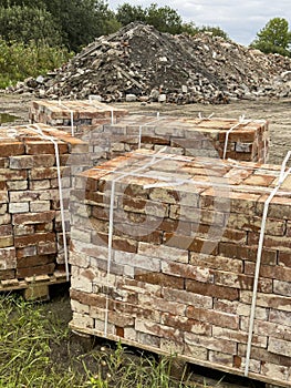 Sourcing red brick from demolition. Stacks of bricks prepared for sale