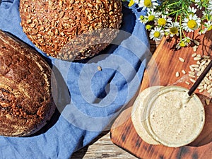 Sourdough for bread in a glass jar, sourdough for the preparation of organic bread at home without sugar. Healthy food concept