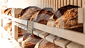 The sourdough bread lies on the shelves in the bakery store - A real rustic artisan bread