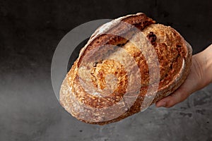 Sourdough bread with mixed fruits and nuts on dark cement background