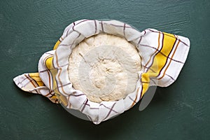 Sourdough set to rise in a bowl, top view photo