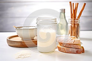 sourdough starter in glass jar next to bread