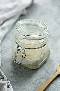 Sourdough starter in a jar, yeast-free leaven starter for healthy organic rustic bread, home baking concept