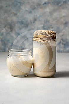 Sourdough starter in jars. Healthy wild fresh homemade yeast for sourdough bread baking.