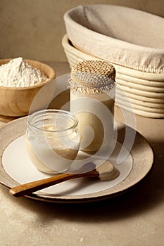 Sourdough starter in jars. Healthy wild fresh homemade yeast for sourdough bread baking.