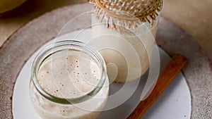 Sourdough starter in jars. Healthy wild fresh homemade yeast for sourdough bread baking.