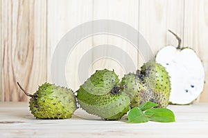 Soursop fruit on wooden table.