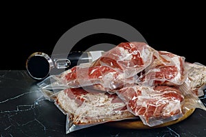 Sous vide immersion circulator cooker and the meats Packeds on a dark background