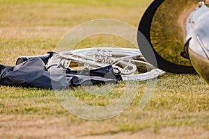 A sousaphone on the grass of the football field at rehearsal photo