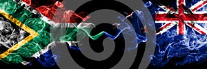 South Africa vs New Zealand, New Zealander smoky mystic flags placed side by side. Thick colored silky abstract smoke flags