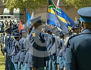South African Police Services on Parade in the arean in formation , side view, flag unfurled and flying