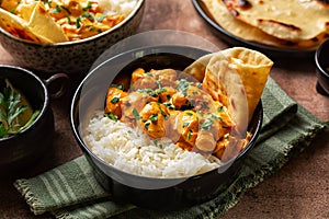 South Asian style, Indian dinner. Chicken curry with long rice and naan bread.