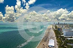 South Beach sandy surface with tourists relaxing on hot Florida sun. Tourism infrastructure in southern USA. Miami Beach