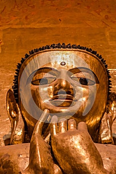 South facing standing Buddha - Kassapa, low angle view of the face - sad look, the Ananda Temple, Old Bagan, Myanmar