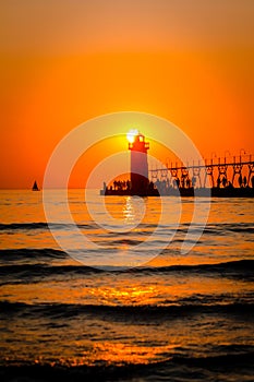 South Haven`s lighthouse and pier on Lake Michigan at sunset