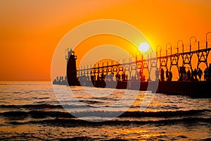 South Haven`s lighthouse and pier on Lake Michigan during sunset