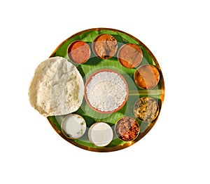 South india meals, meals served on banana leaf brass plate , traditional south indian cuisine, rice, sambar, rasma, appalam, white