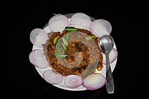 South Indian cuisine Kerala Style Beef fry / roast. Traditional style meat roast. Garnished with onion slices and curry leaves.