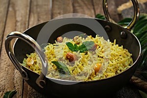 South Indian Curry leaves rice / Karuvepilai sadam served in a Kadai