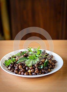 A south indian dish called ground nut masala decorated with mint and curry leaves