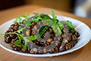 A south indian dish called ground nut masala decorated with mint and curry leaves