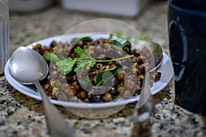 A south indian dish called ground nut masala decorated with mint and curry leaves
