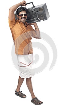 South Indian man listening to a music system