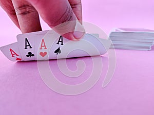 South Indian man raises playing cards to see his cards