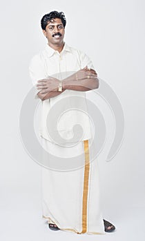 South Indian man standing with his arms crossed and smiling