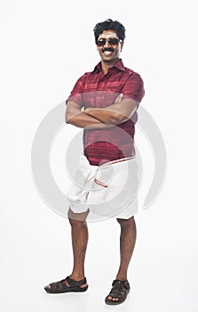 South Indian man standing with his arms crossed and smiling