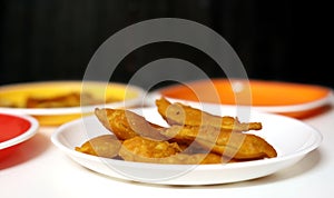 South Indian Potato Snack, Vazhakkai Bajji served on black background