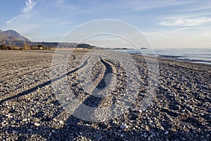 South of Italy, Calabria. Traces from the Car on the Beach against the Blue Sky and Mountains. Amazing Place to Visit in Europe.