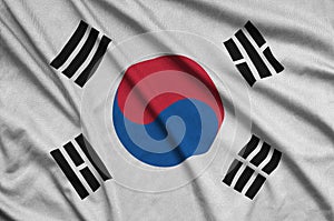 South Korea flag is depicted on a sports cloth fabric with many folds. Sport team banner