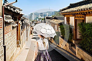 South Korea, Seoul. Woman in hanbok in Bukchon Hanok Village. Girl wearing traditional dress and costume. Korean tradition.