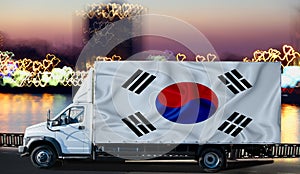 South Korean flag on the side of a white van against the backdrop of a blurred city and river. Logistics concept