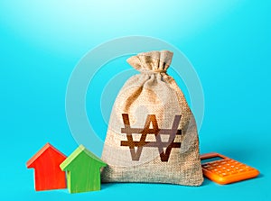 South korean won money bag and small houses. Bank offer of mortgage loan. Investments in real estate. Sale of housing. Buy. Rental