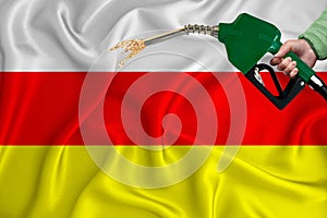 SOUTH OSSETIA flag Close-up shot on waving background texture with Fuel pump nozzle in hand. The concept of design solutions. 3d