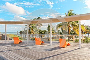 Orange lounge chairs on a wooden deck