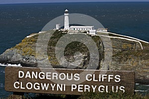 South Stack Lighthouse with dangerous cliffs sign