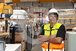 Southeast asia staff engineer worker man portrait confident happy smiling arm crossed in factory warehouse