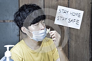 Southeast Asian, Chinese and Myanmar young man with cold flu gets loss of smell called anosmia