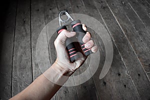 Southeast asian, Chinese young manâ€™s right hand gripping hand exercise gripper